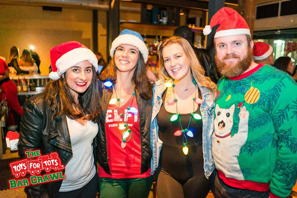 Friends in festive holiday outfits on the bar crawl