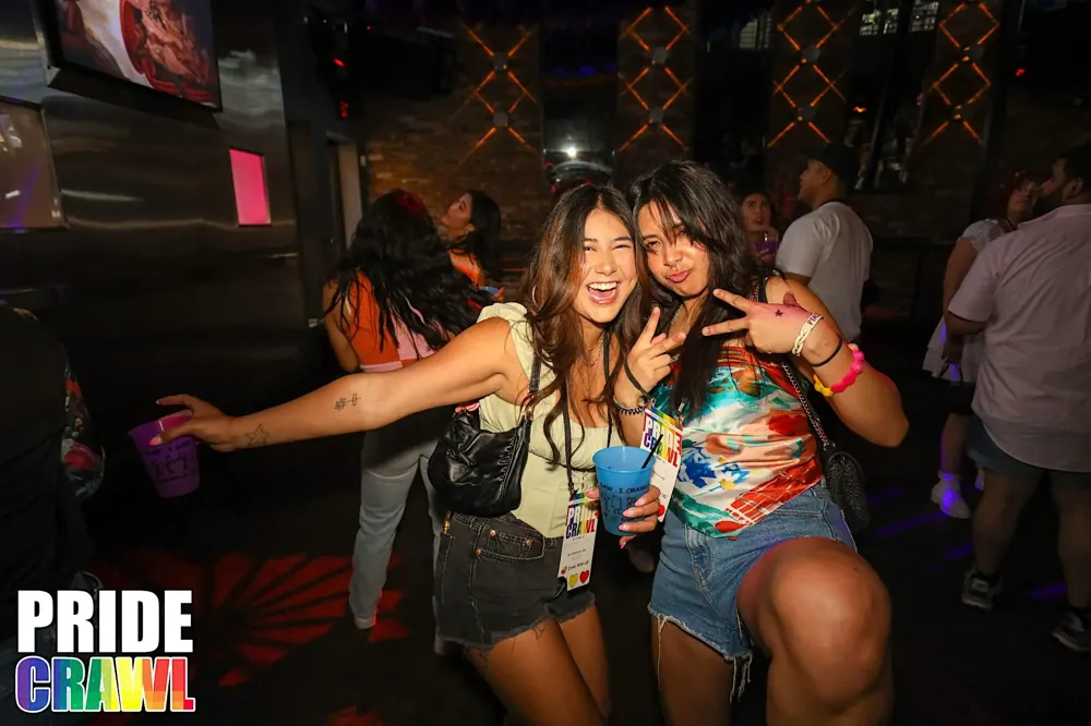 Friends toasting at The Pride Bar Crawl