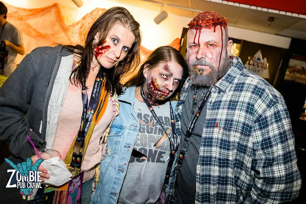 Three crawlers with detailed gory zombie makeup at the Zombie Pub Crawl