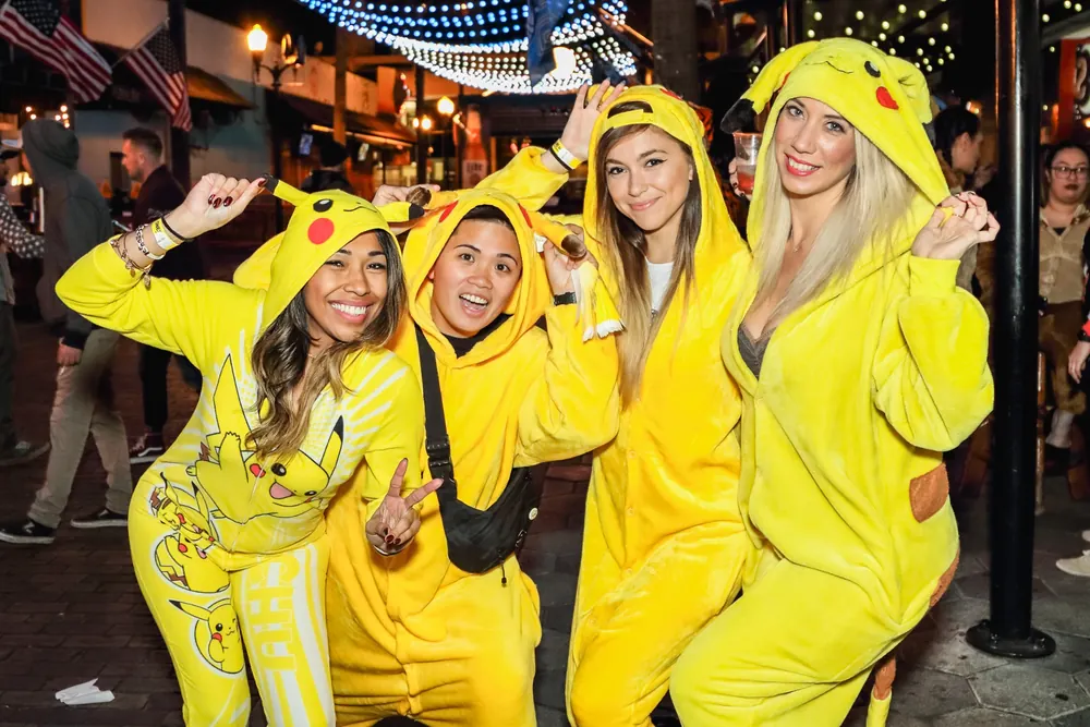 Crawlers in colorful onesies celebrating at The Official Onesie Bar Crawl