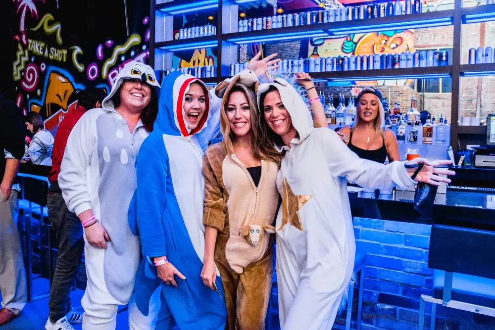 Crawlers in cozy onesies at the Onesie Bar Crawl party