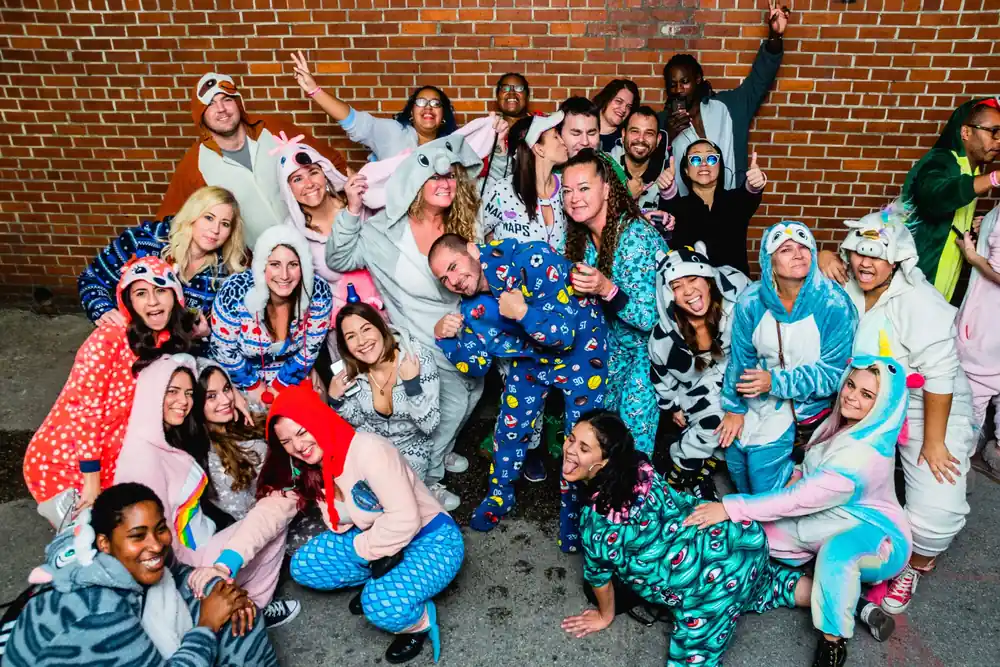 Onesie-clad crawlers celebrating during the bar crawl