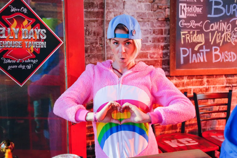 Friends toasting in onesies at the Onesie Bar Crawl